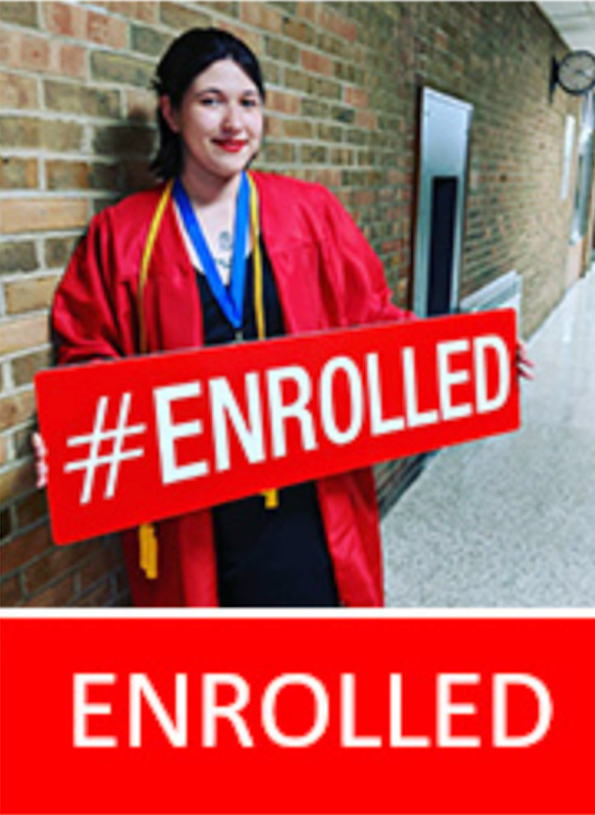 Logan County Graduate holding an enrolled sign