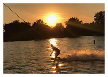 Man water skiing in Indian Lake at sunset