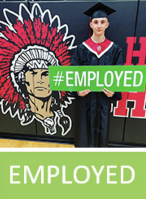Logan County Graduate holding an employed sign
